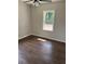 Bright bedroom featuring a ceiling fan, hardwood floors, and a large window offering natural light at 2349 Ousley Ct, Decatur, GA 30032