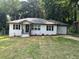 Charming single-story home featuring a freshly landscaped front yard, white brick exterior and an attached garage at 2349 Ousley Ct, Decatur, GA 30032