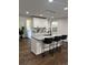 Modern kitchen features white cabinets, granite countertops, stainless steel appliances, and a large kitchen island at 2349 Ousley Ct, Decatur, GA 30032