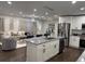 Open-concept kitchen with stainless steel appliances, a granite island, and a view of the living area at 2349 Ousley Ct, Decatur, GA 30032