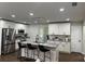 Modern kitchen features white cabinets, granite countertops, stainless steel appliances, and a large kitchen island at 2349 Ousley Ct, Decatur, GA 30032