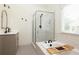 Well-lit bathroom featuring glass shower, bathtub, and stylish black and white tile flooring at 2876 White Oak Dr, Decatur, GA 30032