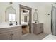 Elegant bathroom featuring double vanities, arched mirrors, and access to the bedroom at 2876 White Oak Dr, Decatur, GA 30032
