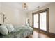 Charming bedroom with French doors, hardwood floors, and light-filled ambiance at 2876 White Oak Dr, Decatur, GA 30032