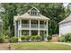 Charming two-story home featuring a double-decker porch and a well-maintained lawn at 2876 White Oak Dr, Decatur, GA 30032