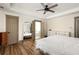 Bright main bedroom with hardwood floors, a ceiling fan, and bathroom and closet entrances at 2876 White Oak Dr, Decatur, GA 30032