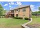 Backyard view featuring a covered deck, lush lawn, and manicured landscaping at 4896 Locklear Way, Marietta, GA 30066