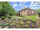 Landscaped backyard with a manicured lawn, mulched beds, and mature trees at 4896 Locklear Way, Marietta, GA 30066