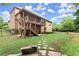 Expansive backyard featuring a multi-tiered deck, stone pathway, and lush landscaping at 4896 Locklear Way, Marietta, GA 30066
