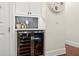 Modern bar area featuring a stainless steel beverage cooler, built-in cabinets, and stylish decor at 4896 Locklear Way, Marietta, GA 30066
