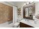 Well-lit bathroom featuring a decorative mirror, tiled shower, and modern fixtures at 4896 Locklear Way, Marietta, GA 30066