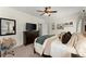 Spacious bedroom has a dark wood dresser, ceiling fan, and desk at 4896 Locklear Way, Marietta, GA 30066