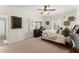 Cozy bedroom features a ceiling fan, dark furniture, and decoratively appointed wall art at 4896 Locklear Way, Marietta, GA 30066