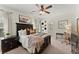 Bedroom features a ceiling fan, dark wood furniture, desk, and decorative wall art at 4896 Locklear Way, Marietta, GA 30066
