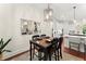 Cozy dining area adjacent to the kitchen, featuring a modern light fixture and seating for four at 4896 Locklear Way, Marietta, GA 30066