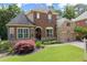 Charming two-story brick home featuring a manicured lawn, stone accents, and a two-car garage at 4896 Locklear Way, Marietta, GA 30066
