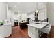 Bright kitchen boasts a central island, white cabinetry, herringbone backsplash, and stainless steel appliances at 4896 Locklear Way, Marietta, GA 30066