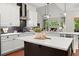 Stylish kitchen with an island, herringbone backsplash, stainless steel appliances, and a view to the Gathering room at 4896 Locklear Way, Marietta, GA 30066