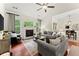 Cozy living room featuring a fireplace, hardwood floors, neutral paint, and large windows at 4896 Locklear Way, Marietta, GA 30066
