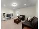 Cozy living room features recessed lighting, neutral carpet, with a plush leather sofa at 4896 Locklear Way, Marietta, GA 30066