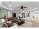 Inviting living room features an oversized couch, ceiling fan, and decorative rug at 4896 Locklear Way, Marietta, GA 30066