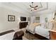 Main bedroom with tray ceilings, ceiling fan, and hardwood furniture at 4896 Locklear Way, Marietta, GA 30066