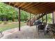 Covered patio area with stone flooring and steps to the backyard, perfect for entertaining at 4896 Locklear Way, Marietta, GA 30066