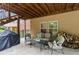 Covered patio area with stone flooring, a grill, and comfortable seating at 4896 Locklear Way, Marietta, GA 30066