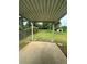View of the backyard from under the patio, showing green grass and shed at 213 Peartree Ln, Riverdale, GA 30274