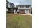 Traditional two-story home with brick and vinyl siding and a well-maintained front yard at 213 Peartree Ln, Riverdale, GA 30274