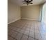 Large tiled room with ceiling fan and lots of natural light through sliding glass doors at 213 Peartree Ln, Riverdale, GA 30274