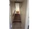Stairway with carpet leading to a view of living room and kitchen at 213 Peartree Ln, Riverdale, GA 30274