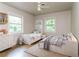 Cozy bedroom featuring two beds, hardwood floors, and a window with a view of the outdoors at 2582 Springdale Sw Rd, Atlanta, GA 30315