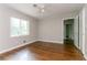 Bright bedroom with hardwood floors, ceiling fan, and a large window overlooking lush greenery at 2582 Springdale Sw Rd, Atlanta, GA 30315