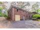 Two-story brick home featuring a side-entry garage and ample parking space at 2582 Springdale Sw Rd, Atlanta, GA 30315