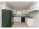 Compact kitchen featuring white cabinets, a black refrigerator, and a window above the sink at 2582 Springdale Sw Rd, Atlanta, GA 30315