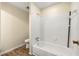 Bathroom featuring a white tiled shower over tub and wood look flooring at 3184 Nectarine Cir, Decatur, GA 30034