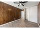 Cozy bedroom featuring wood paneled accent wall, ceiling fan and closet at 3184 Nectarine Cir, Decatur, GA 30034