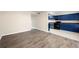 Kitchen with hardwood floors, stainless steel appliances, and vibrant blue cabinets at 3184 Nectarine Cir, Decatur, GA 30034