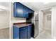 Modern kitchen showcasing stainless steel appliances, blue cabinets and hardwood floors at 3184 Nectarine Cir, Decatur, GA 30034