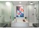 Sleek primary bath featuring a modern soaking tub, glass shower, and contemporary art at 45 Ivan Allen Jr Nw Blvd # 2505, Atlanta, GA 30308