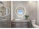 Modern bathroom featuring a sleek vanity with round LED mirror, designer tiles, and glass-enclosed shower at 45 Ivan Allen Jr Nw Blvd # 2505, Atlanta, GA 30308