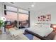 Bright bedroom features city skyline views through large windows, with contemporary decor and plush bedding at 45 Ivan Allen Jr Nw Blvd # 2505, Atlanta, GA 30308