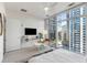 Well-lit bedroom with floor-to-ceiling windows, modern furnishings, and a comfortable sitting area at 45 Ivan Allen Jr Nw Blvd # 2505, Atlanta, GA 30308