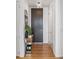 Hallway with hardwood floors, featuring a modern accent table with decorative items at 45 Ivan Allen Jr Nw Blvd # 2505, Atlanta, GA 30308