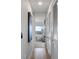 Bright hallway showcasing hardwood floors, a modern art piece, and access to a bedroom with city views at 45 Ivan Allen Jr Nw Blvd # 2505, Atlanta, GA 30308
