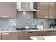 Modern kitchen detail showcases granite countertops, stainless steel gas range, and stylish backsplash at 45 Ivan Allen Jr Nw Blvd # 2505, Atlanta, GA 30308