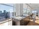 Sleek kitchen island with granite countertops, sink, and city view provides open concept modern living at 45 Ivan Allen Jr Nw Blvd # 2505, Atlanta, GA 30308