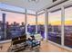 Comfortable seating area with floor-to-ceiling windows offering panoramic city views at sunset at 45 Ivan Allen Jr Nw Blvd # 2505, Atlanta, GA 30308