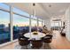 Bright living space with round dining table and floor-to-ceiling windows offering stunning city views at 45 Ivan Allen Jr Nw Blvd # 2505, Atlanta, GA 30308